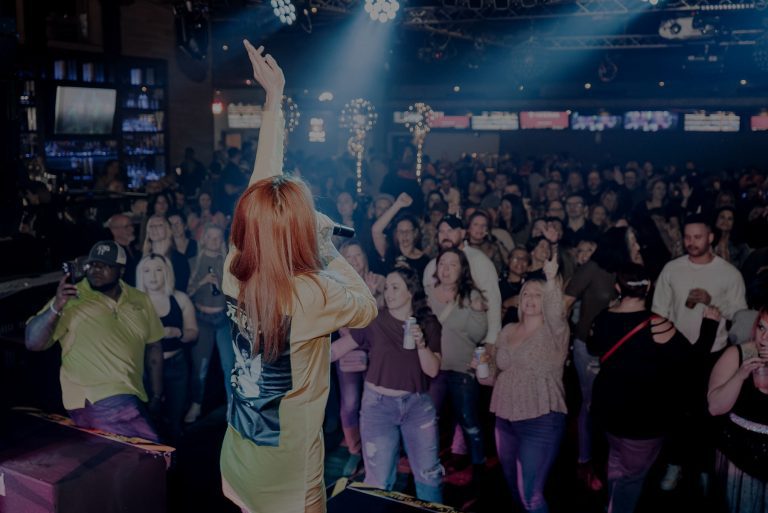 Singer performing to a packed crowd at Twain's Tavern
