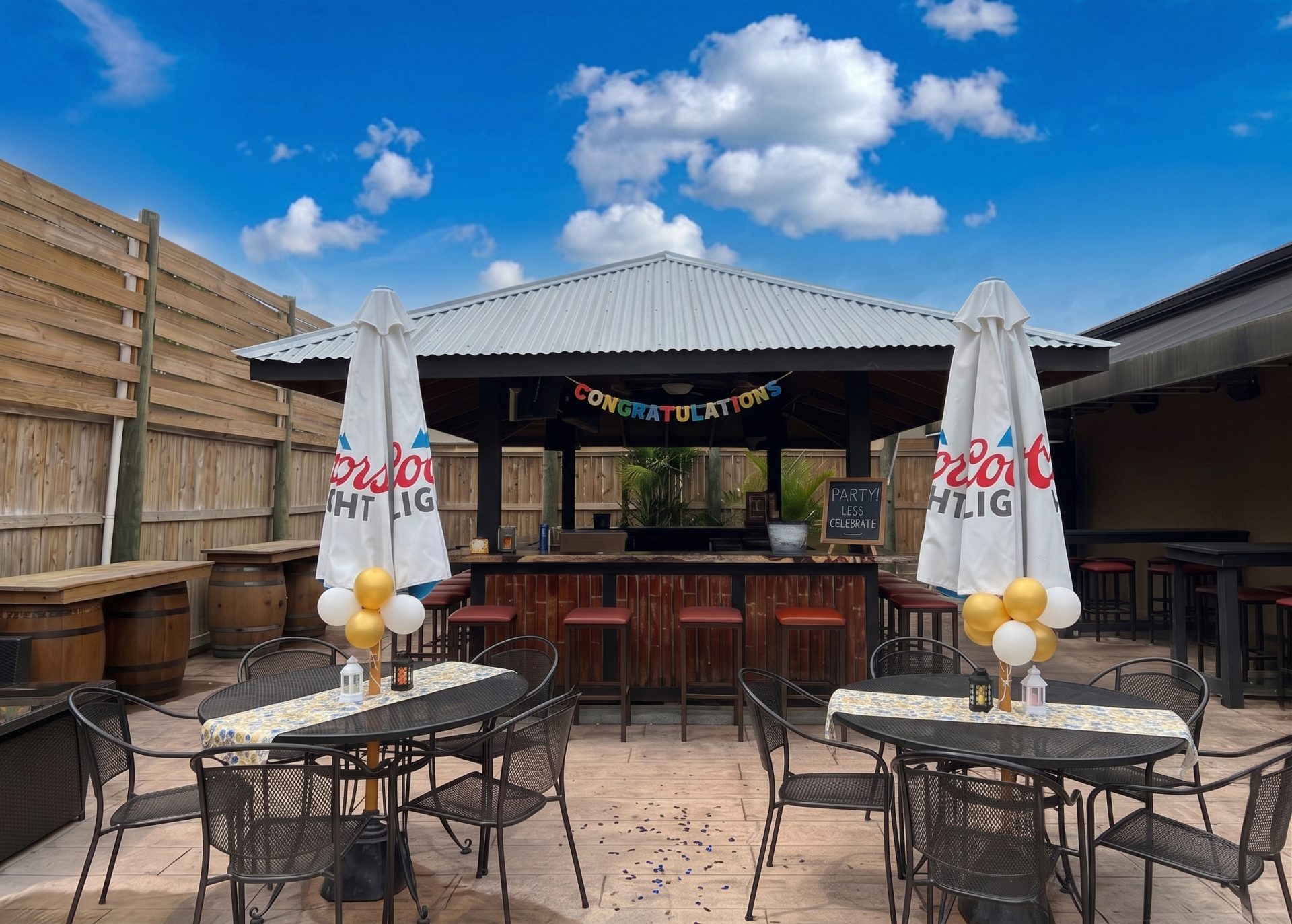 Outdoor patio bar with pergola and string lights at Twain's Tavern