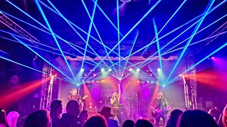 A live band under the lasers on the stage at Twain's Tavern