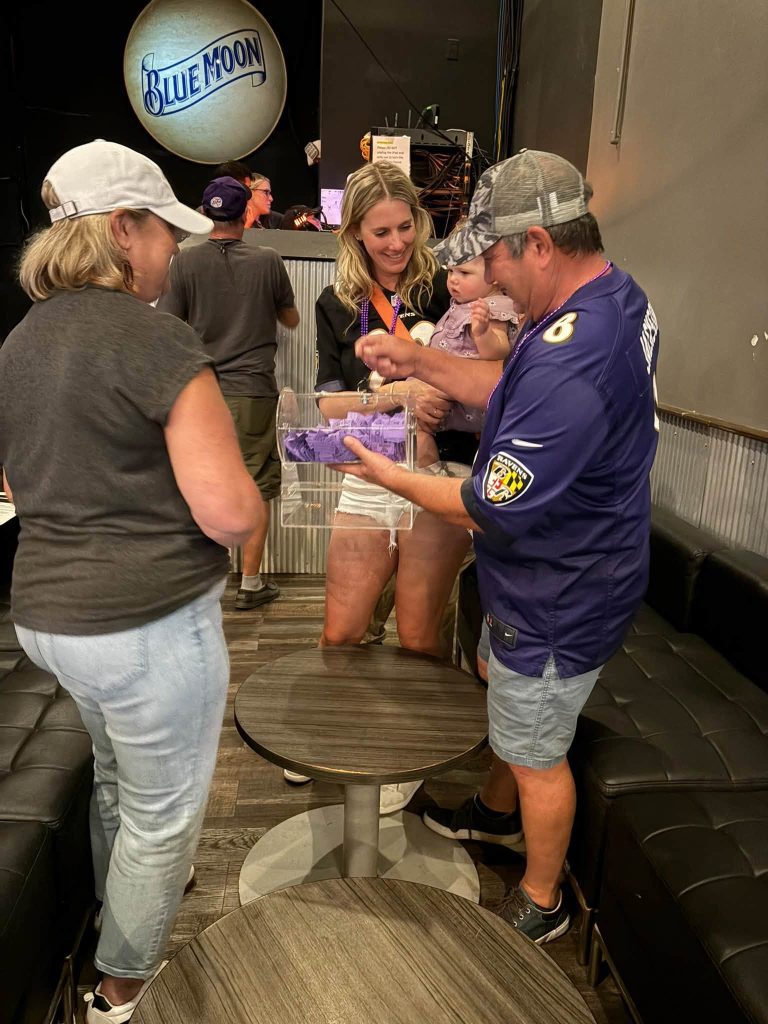 Drawing raffle tickets at a Ravens watch party at Twain's Tavern