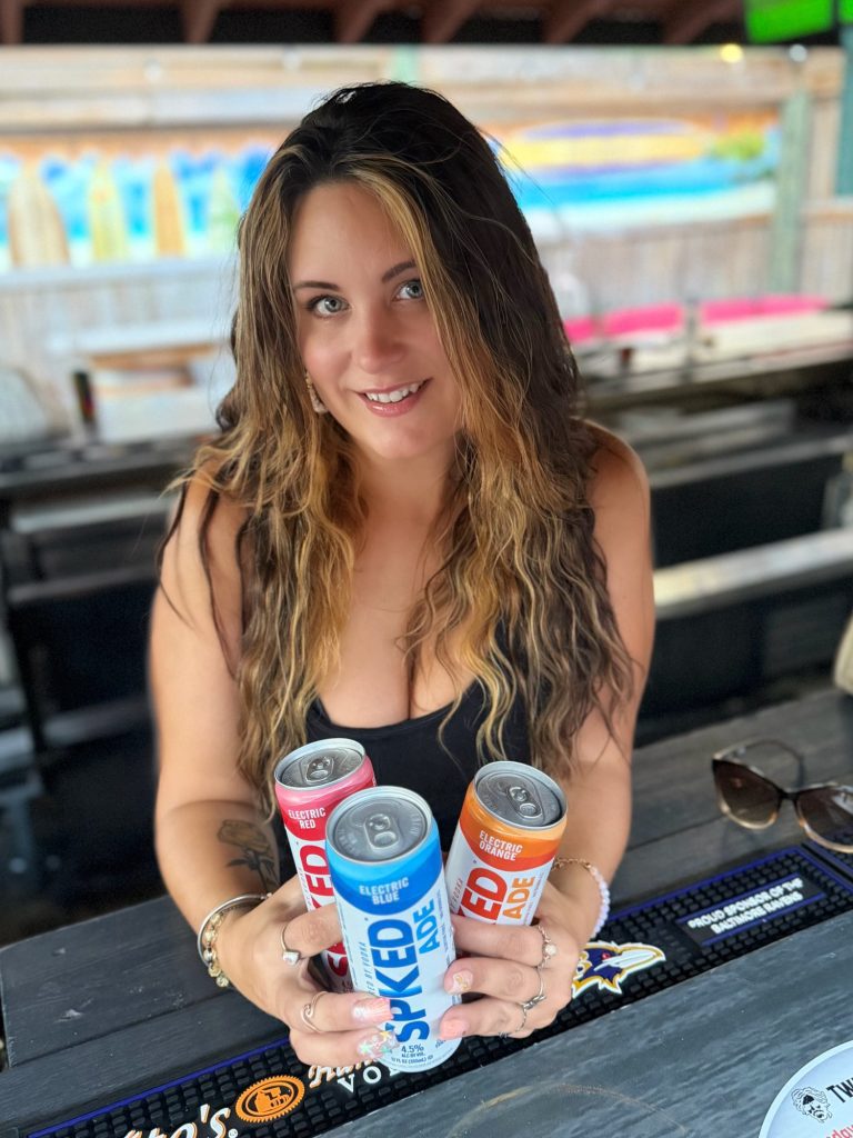 Bartender holding hard seltzers at Twain's Tavern tiki bar